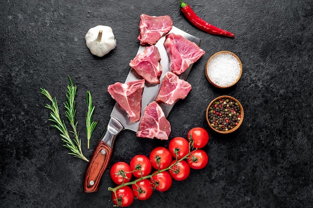 raw T-Bone steak on a knife on a stone table