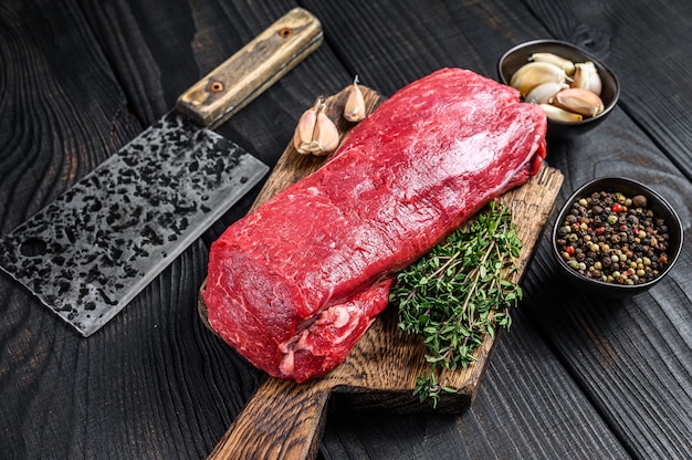 Raw Tenderloin beef meat for steaks fillet mignon on a wooden cutting board