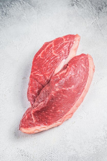 Raw top sirloin steak cap rump beef meat steak White background Top view