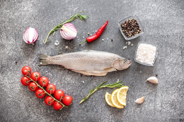 Raw trout fish on stone background