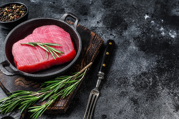 Raw tuna fillet with rosemary in a pan