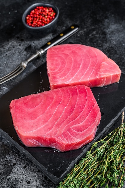 Raw tuna steak on a marble cutting Board