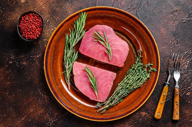 raw tuna steaks on table