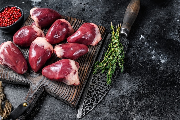 Raw turkey hearts offal with herbs and spices