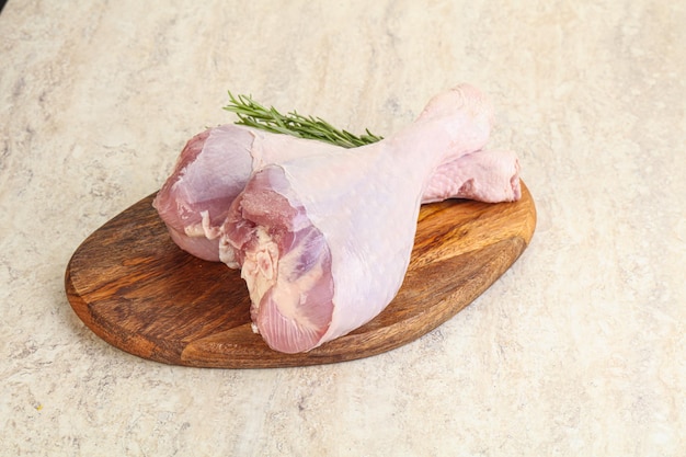 Raw turkey leg for cooking served rosemary