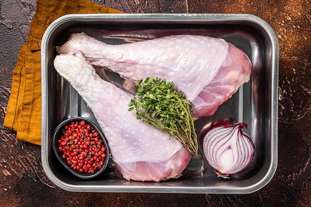 Raw turkey legs Drumsticks Poultry meat Dark background Top view