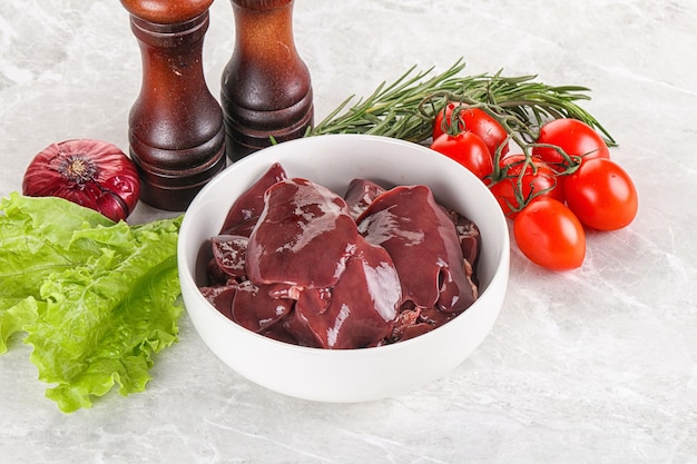 Raw turkey liver in a bowl ready for cooking with herbs and spices