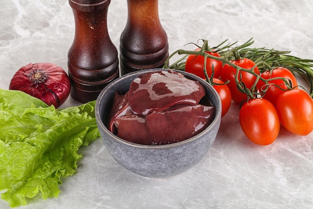 Raw turkey liver in a bowl ready for cooking with herbs and spices