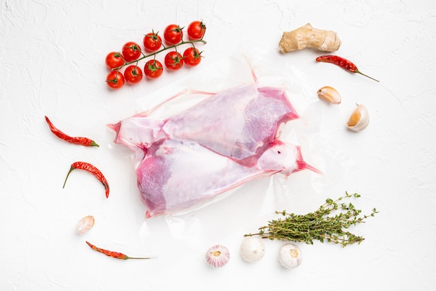 Raw turkey thigh vacuum pack top view flat lay on white stone table background