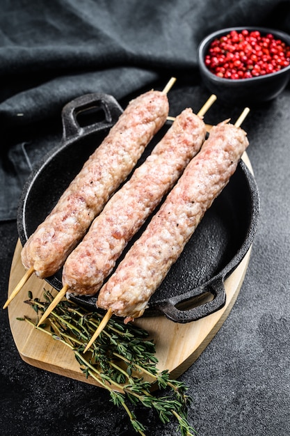 Raw turkish traditional meat kebab. black background