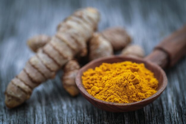 Raw turmeric with powder clsose up