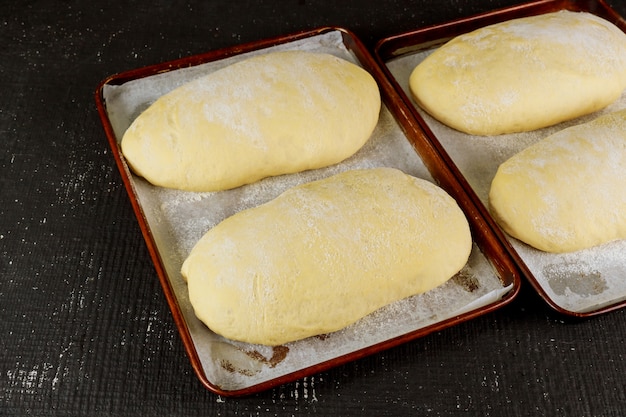 Raw uncooked bread in pan ready for baking.