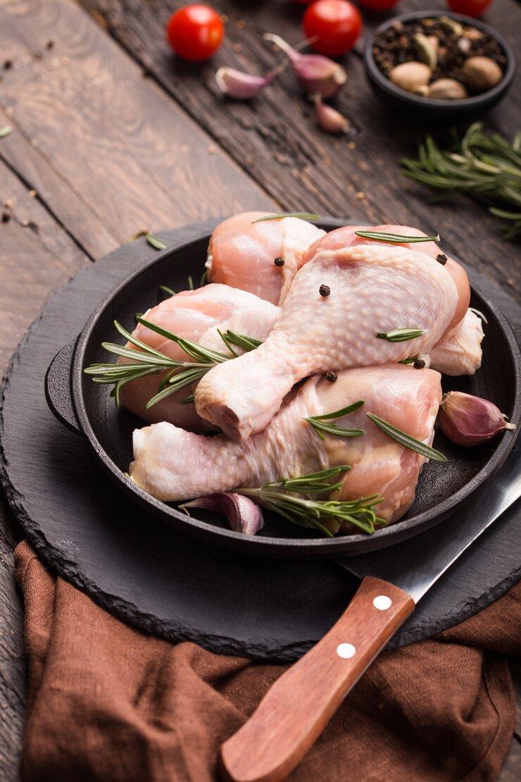 Raw uncooked chicken legs with herbs