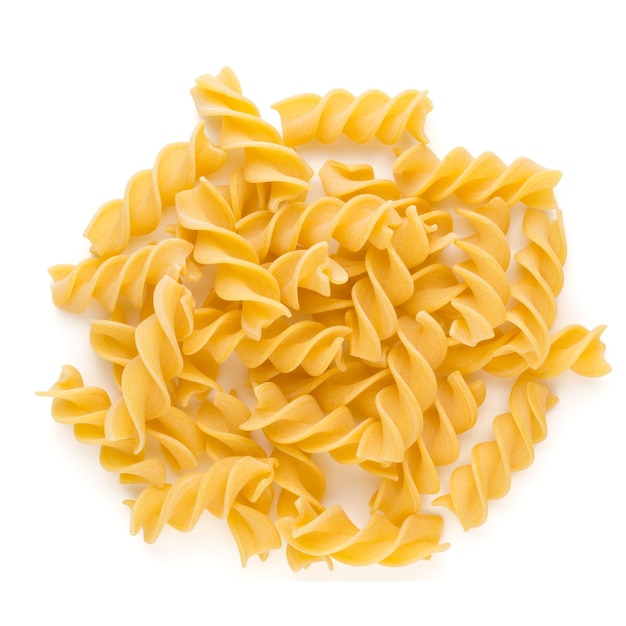 Raw uncooked pasta penne on the white surface.