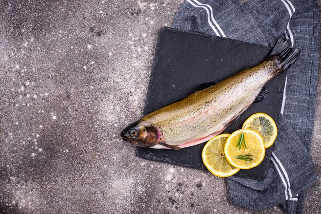 Raw uncooked trout with lemon