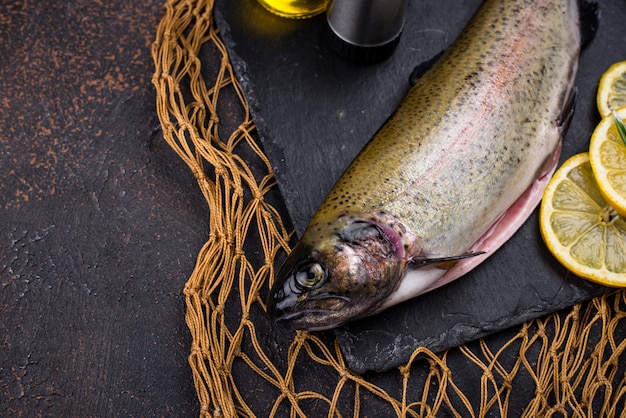 Raw uncooked trout with lemons