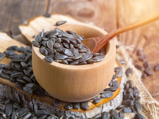 Raw unshelled sunflower seeds on a rustic background seeds on an old tree