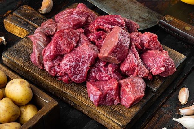 Raw veal beef for stew set, on old dark  wooden table