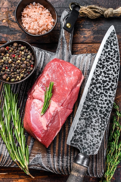 Raw veal sirloin meat steak on a wooden board