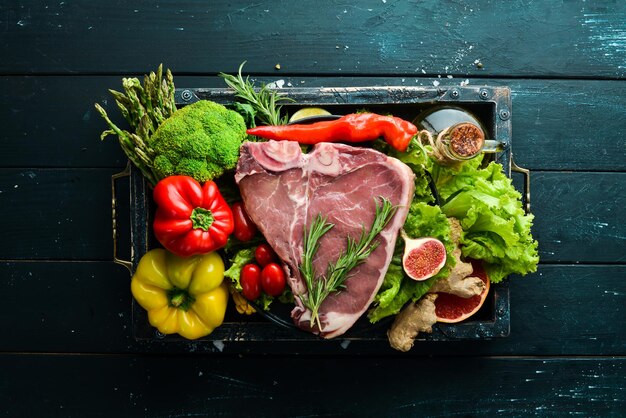 Raw veal steak with vegetables Healthy eating concept Top view Free copy space