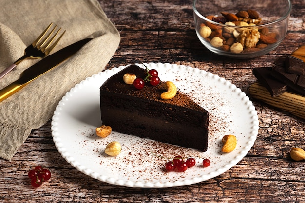 Raw vegan chocolate cake on dark vintage background