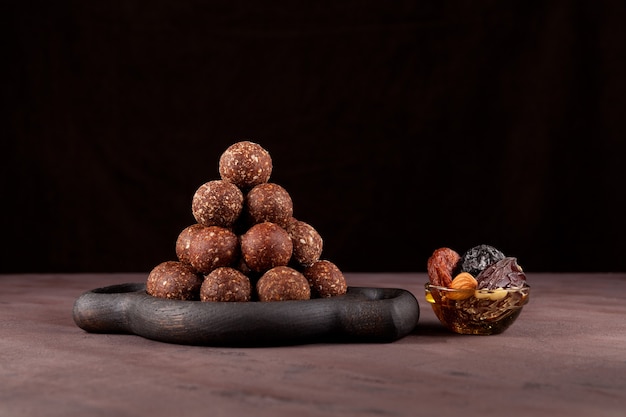 Raw vegan sweets, energy balls of dried fruits and nuts with honey