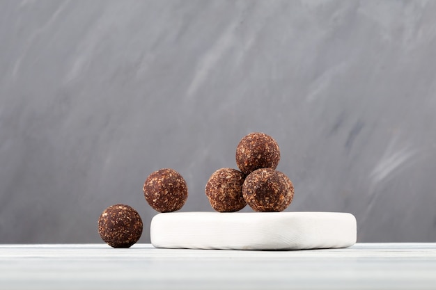 Raw vegan sweets energy balls with dried fruits coconut and carob powder