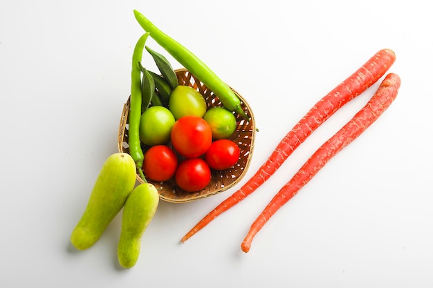 Raw vegetable in wooden bowl on white background.