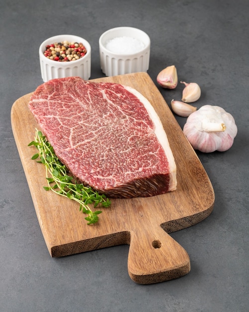 Raw wagyu shoulder roast meat over wooden board with seasonings