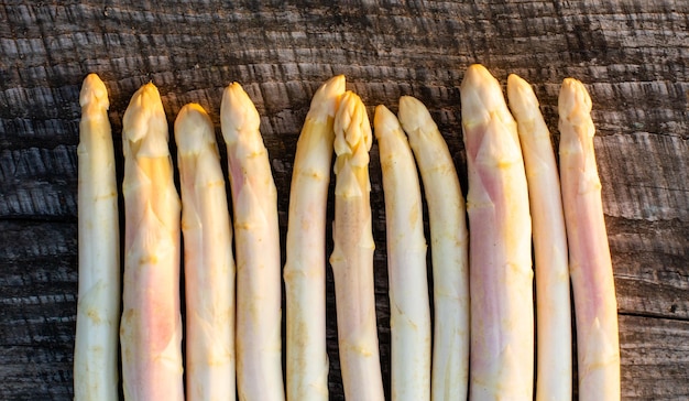 Raw white asparagus on the wooden table