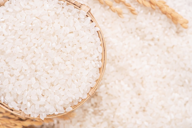 写真 茶色のボウル、有機農業のデザインコンセプトの白い背景に生の白い磨かれた製粉食用米作物。アジアの主食、クローズアップ。