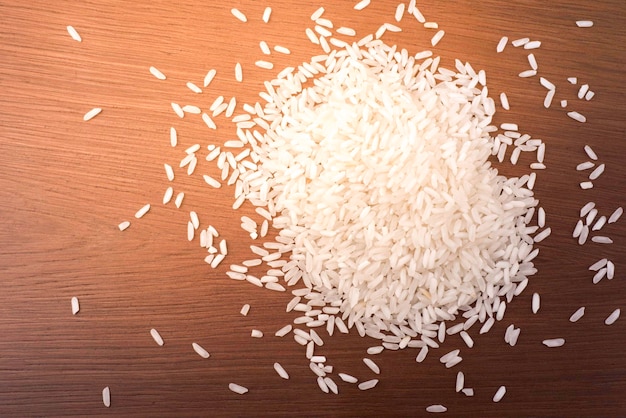 raw white rice scattered on the table photo closeup.