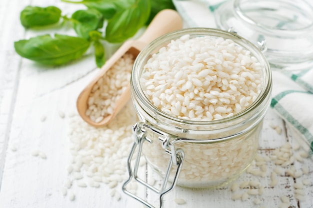 Raw White rice variety Arborio for Italian risotto dishes in glass jar