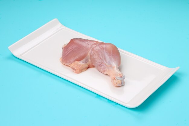 Raw whole chicken leg without skin arranged rectangle shape flat tableware