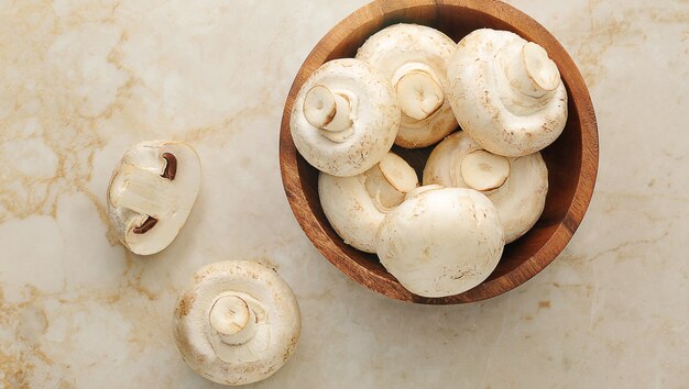 Raw whole mushrooms in a wooden bowl