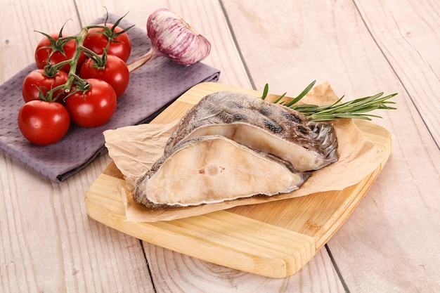 Raw wolffish steak for cooking served rosemary