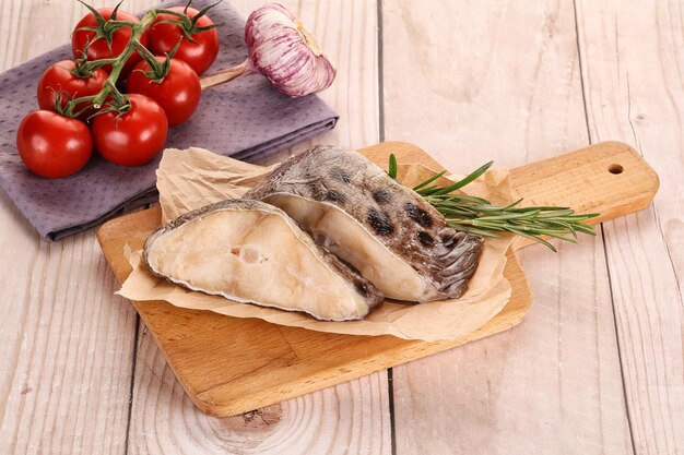 Raw wolffish steak for cooking served rosemary