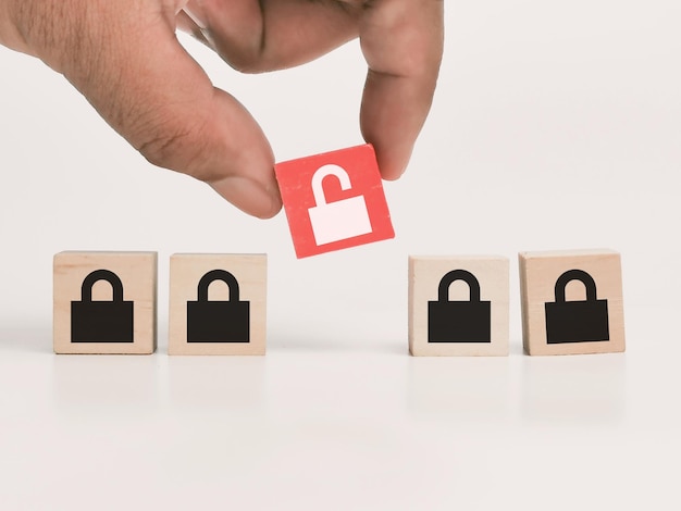 A raw of wooden cubes with lock icons with hand.