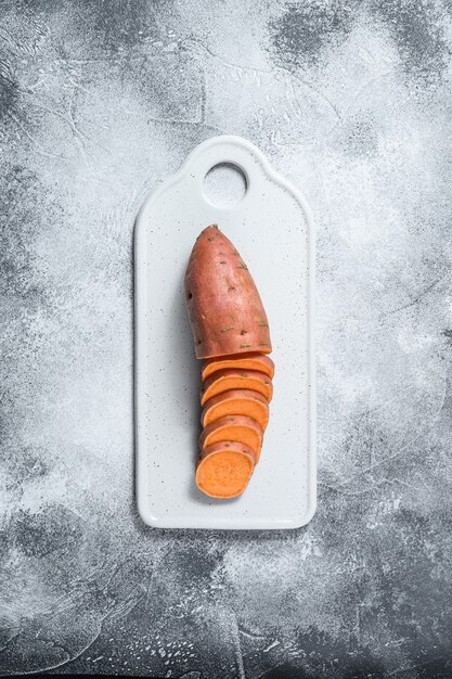 Raw yam on a chopping Board, organic batatas