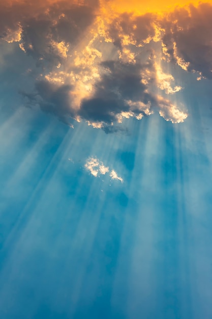 Ray of sunlight breaking through clouds at sunset.