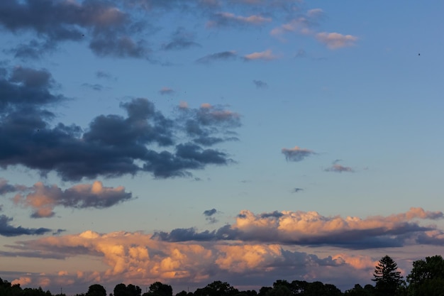 The rays of the setting sun glide over a dark overcast cloud Overcast weather