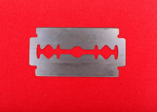 Razor blade on color background