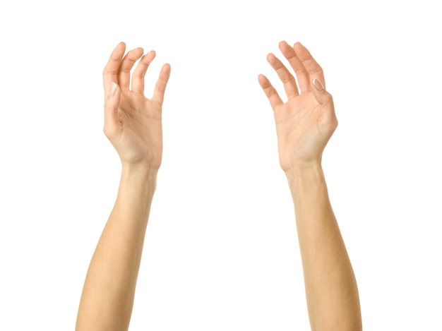 Reaching hand. Woman hand with french manicure gesturing isolated on white wall. Part of series