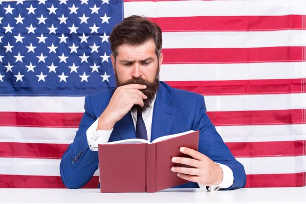 Read explanation to learn more Teacher read book on USA flag background Teaching to read Literacy study School and education Language courses American English Read and understand