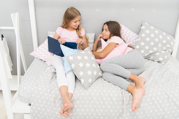 Read to me. Little girl read story to sister. Small kids read before bed. Literature and library. Children development. Developing imagination through reading. Just want nice bedtime read.