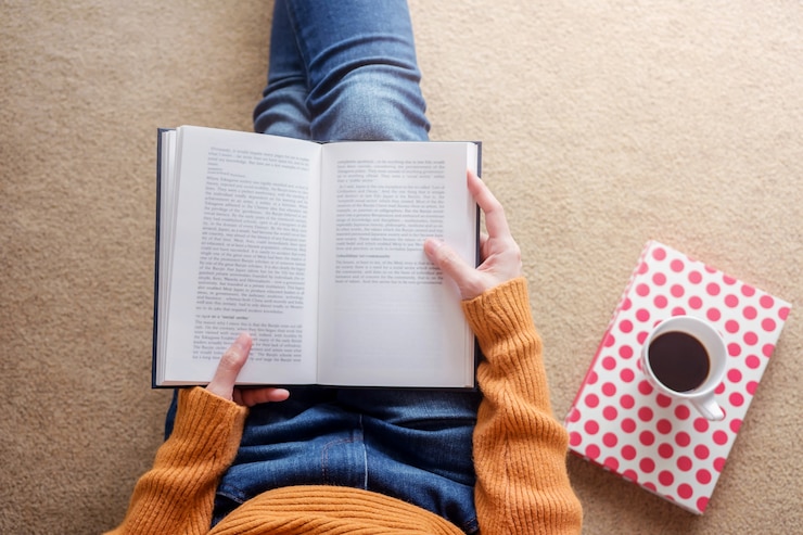 Reading Concept. Soft Focus of  Young Woman Relaxing by Book in Cozy House