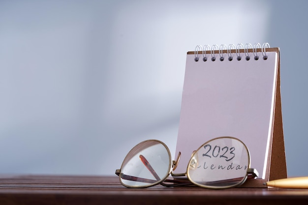 Reading eyeglasses and 2023 desk calendar