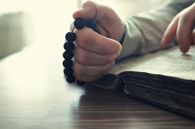 Reading religious literature a man studies the koran and sorts\
out the rosary