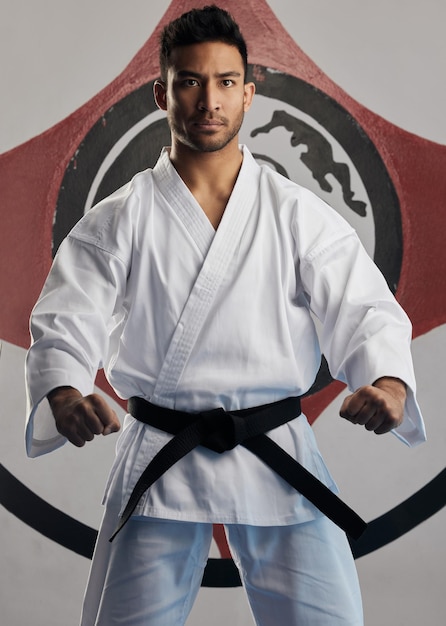Photo ready for a fight cropped portrait of a handsome young martial artist practicing karate in his dojo