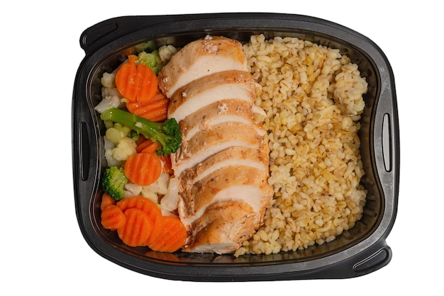 Ready food in a container. Stewed chicken, stewed carrot, cabbage and porridge. Isolated on white.